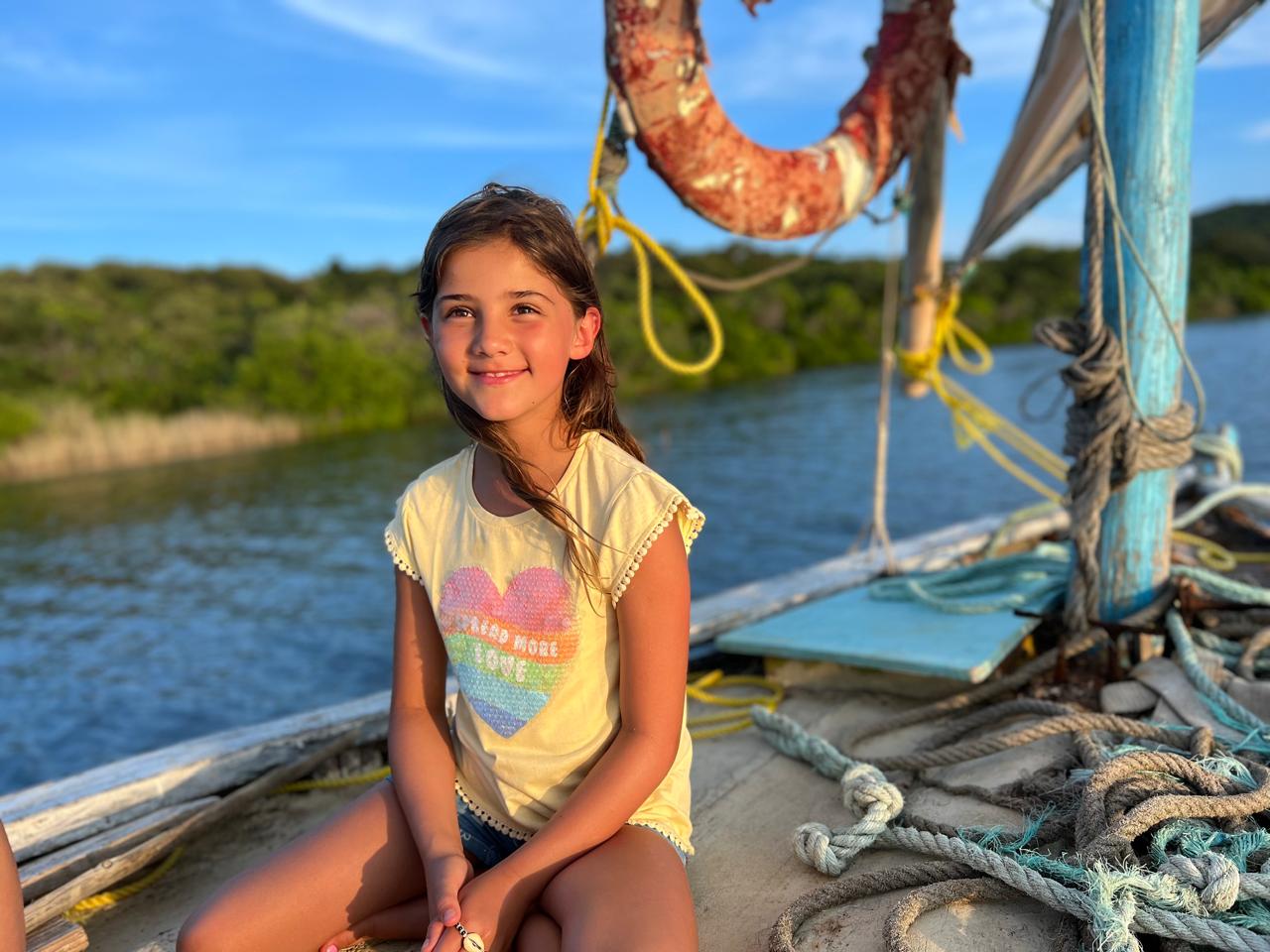 Mica on a sailboat at sunset