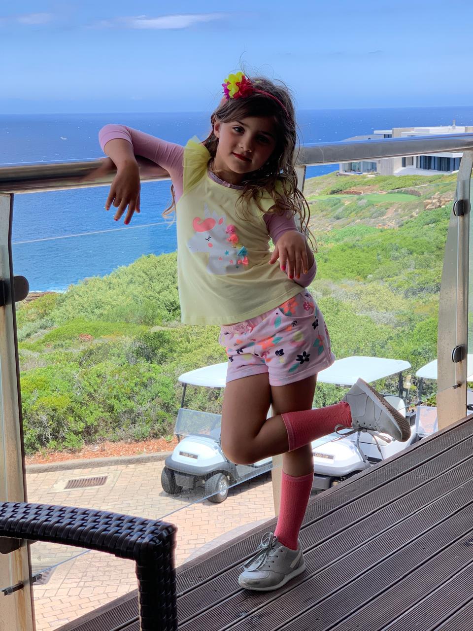 Mica striking a pose with an ocean view