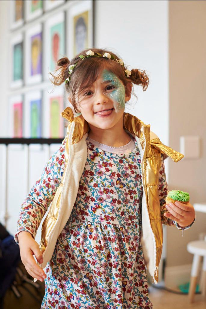 Mica with face paint and a cupcake