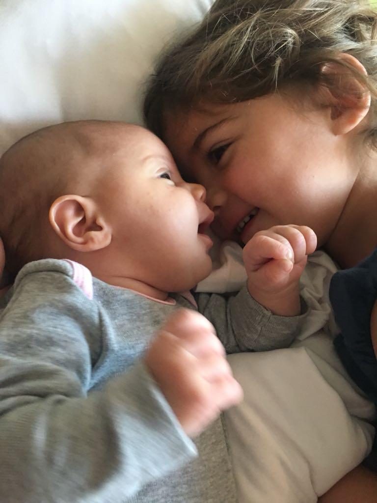 Mica nose-to-nose with baby sister