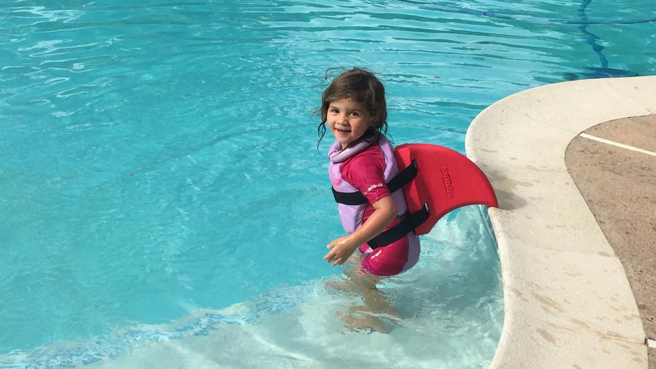 Mica swimming with a kickboard