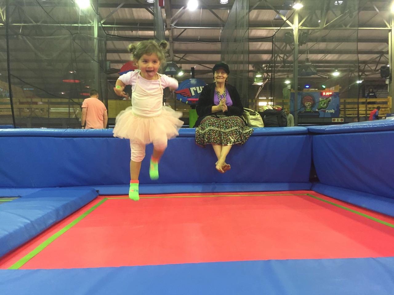 Mica jumping on a trampoline in a tutu