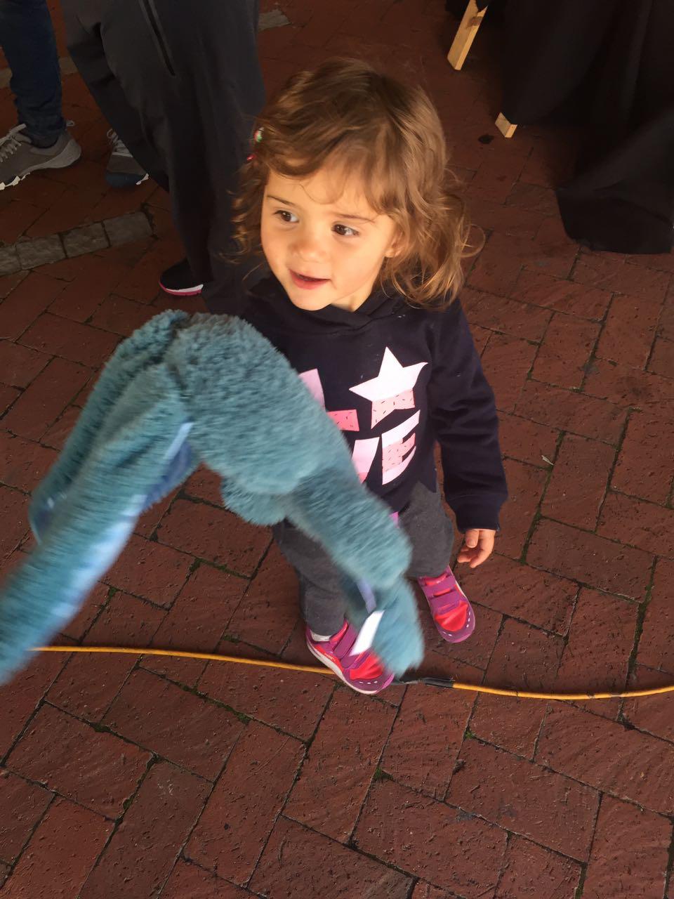 Mica playing with her blue bunny toy