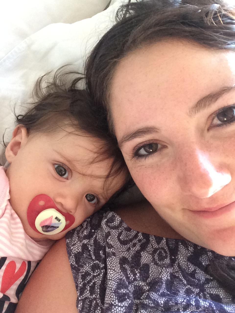 Baby Mica snuggled up with Mom for a selfie